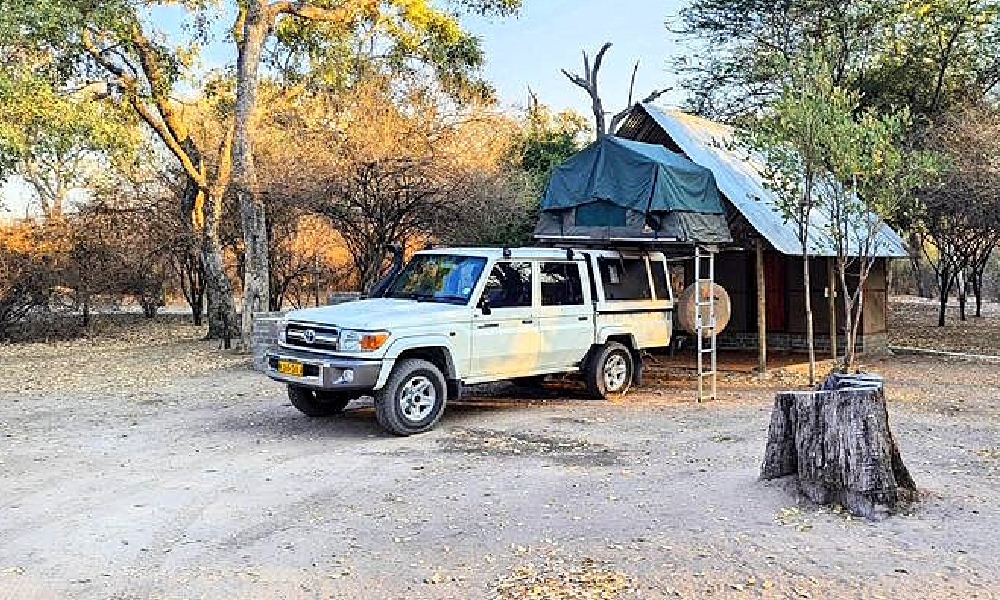 Camping-equipped 4x4 vehicle in a safari setting